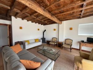a living room with a couch and a fireplace at AlcaidariaVista in Ourém