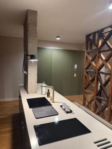 a kitchen with a counter top with a sink at Casa das Tertúlias in Leiria