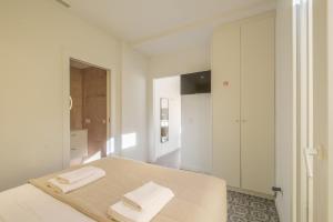a bedroom with a bed with two towels on it at Marvellous Apt with a Large Private Terrace in Valencia