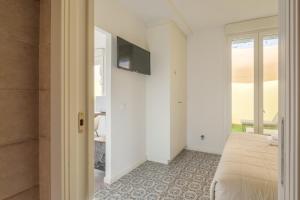 a bedroom with a bed and a television on a wall at Marvellous Apt with a Large Private Terrace in Valencia