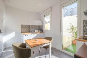 a kitchen with a table and chairs and a window at Marvellous Apt with a Large Private Terrace in Valencia