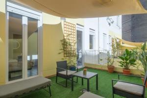 a patio with a table and chairs on a balcony at Marvellous Apt with a Large Private Terrace in Valencia