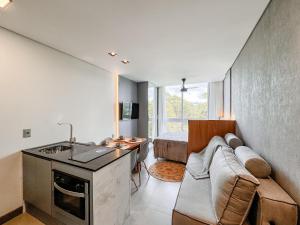 a living room with a couch and a table in a room at Livin517 in Xangri-lá +9 photos