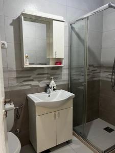 a bathroom with a sink and a shower at Sun Stay in Bar