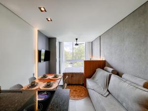 a living room with a couch and a table at Livin517 in Xangri-lá