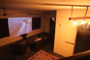 a living room with a large flat screen tv at Hidden Pearl Beach Villa in Pondicherry
