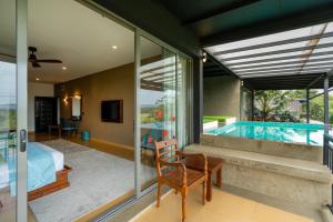a room with a bed and a swimming pool at Trio Lodge- Habarana in Habarana +30 photos