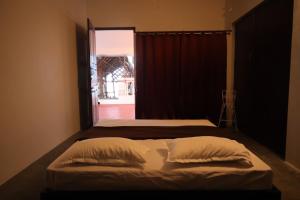 a bedroom with two beds and a window at Hidden Pearl Beach Villa in Pondicherry