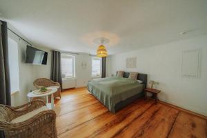 a bedroom with a bed and a wooden floor at Residenz Moselliebe in Traben-Trarbach