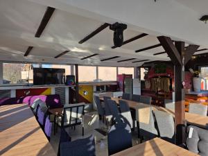 a dining room with tables and chairs and a television at vila darkoni in Bijeljina