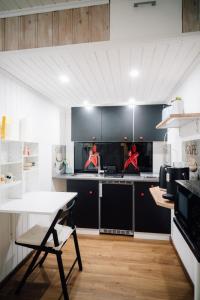 a kitchen with black cabinets and a table in it at Ferienwohnung Gierschner in Kronach