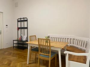 a dining room with a wooden table and chairs at Villa Jahn in Baden +2 photos