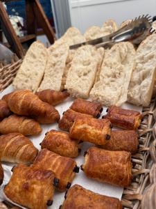 a bunch of bread and pastries on a table at Le Grand Hotel in Forcalquier +53 photos