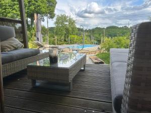 a patio with a couch and a table and a pool at Le Blanc Spa in Nanteuil-en-Vallée