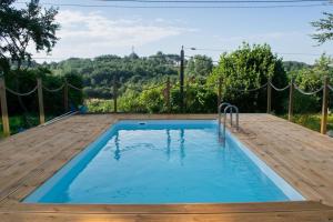 a small swimming pool with a wooden deck and a wooden at Le Blanc Spa in Nanteuil-en-Vallée +17 photos