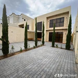 a building with trees in front of it at شاليهات بيات فيلا نورسين in Abha