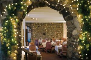 a dining room with tables and chairs and christmas lights at Hotel Locanda dell'Oca Bianca in Como