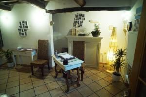 a room with a table and chairs and a fireplace at Affittacamere Fulginiae in Foligno