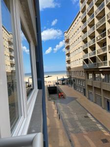a view of the beach from a hotel window at logies One Room, Sea view in Ostend