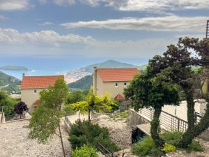 a view of a house with mountains in the background at Golden Horizon Villas in Budva