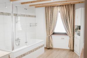 a bathroom with a bath tub and a window at Haus Erlenau in Dalaas +31 photos