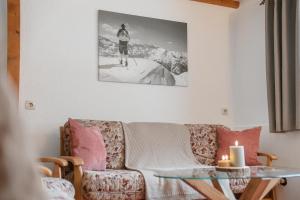a living room with a couch and a table at Haus Erlenau in Dalaas