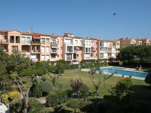 an apartment complex with a swimming pool and a park at Apartment in Empuriabrava by the Beach in Empuriabrava +23 photos
