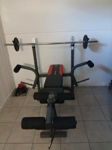 a black and red exercise bike against a wall at Alby in Alby +4 photos