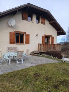 a house with a table and chairs in front of it at Alby in Alby