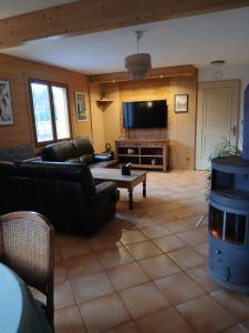 a living room with a couch and a tv at Alby in Alby