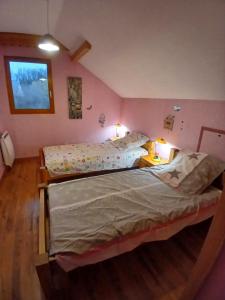 two beds in a room with pink walls at Alby in Alby