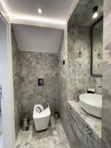 a bathroom with a white toilet and a sink at Castle View Serenity in Koroni