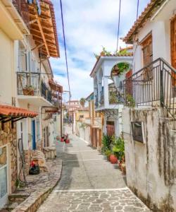 an alley in an old town with buildings at Castle View Serenity in Koroni