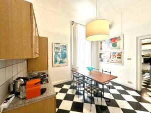 a kitchen with a table and a dining room at Milonghita Apartment Ortigia by Ortigiaapartments in Syracuse