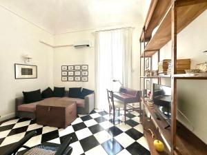 a living room with a couch and a checkered floor at Milonghita Apartment Ortigia by Ortigiaapartments in Syracuse +7 photos