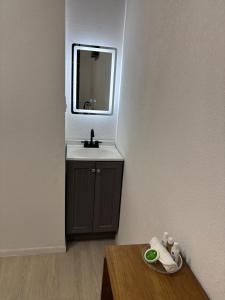 a bathroom with a sink and a mirror and a table at Borunda Suites in General Trías +4 photos