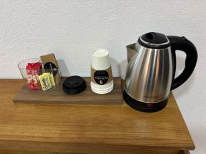 a coffee maker sitting on top of a wooden shelf at Borunda Suites in General Trías