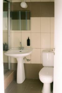 a bathroom with a sink and a toilet at Kymo Fig Tree Bay House in Protaras +73 photos