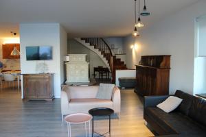 a living room with a couch and a chair at Villa Manuela-Lake View in Brenzone sul Garda