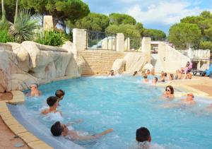 a group of people in a swimming pool at Camping Les Cigales - Aquatique Vacances in Le Muy