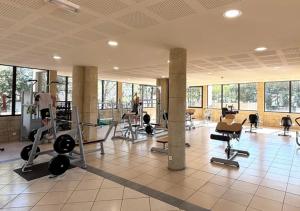 a gym with treadmills and machines in a room at Camping Les Cigales - Aquatique Vacances in Le Muy +6 photos