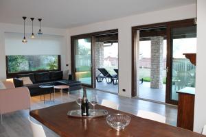 a living room with a table and a couch at Villa Manuela-Lake View in Brenzone sul Garda