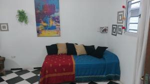 a bedroom with a bed with a colorful blanket at Hospedaje San Vicente in San Vicente