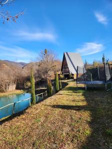 a house next to a river with a swing at Colorful Space in Kotoraantkari