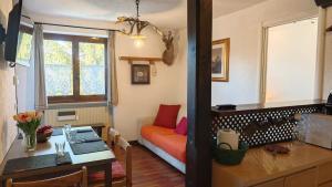 a living room with a couch and a table at Hostdomus - La Tana della Volpe in Sauze d'Oulx