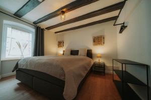 a bedroom with a large bed and a window at Residenz Moselliebe in Traben-Trarbach