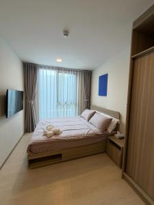 a bedroom with a large bed and a television at Rest&Rise Phuket in Ban Rangeng +7 photos