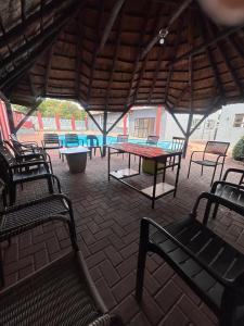a group of chairs and a table in a pavilion at L-PACK PRIMROSe in Germiston