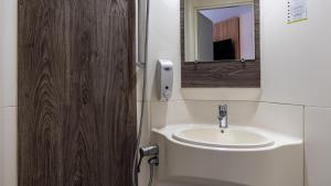 a bathroom with a sink and a mirror at Kyriad ECO - Anglet Côte Basque in Anglet +17 photos