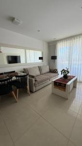 a living room with a couch and a table at Punta del Este, Sol y Luna II, Departamento 301 in Punta del Este